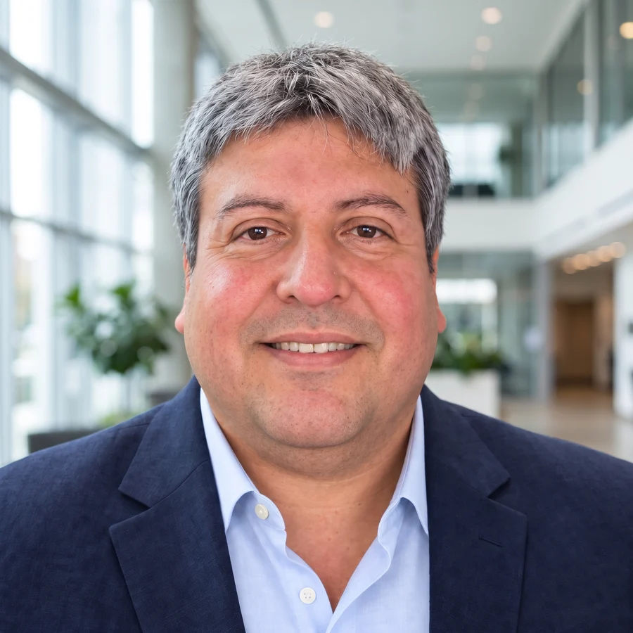 Portrait of Miguel Rojas Chavez, founder and owner of Verily Clean, in a navy blazer and light blue shirt